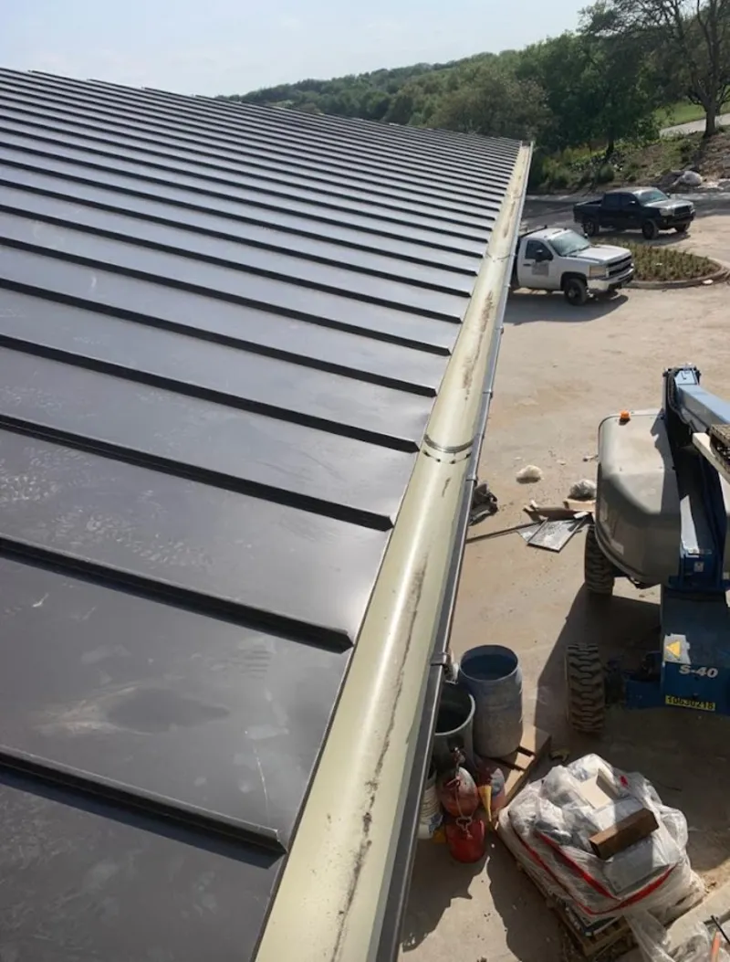 Standing seam panel and gutter detail on a metal roofing jobsite in Renton